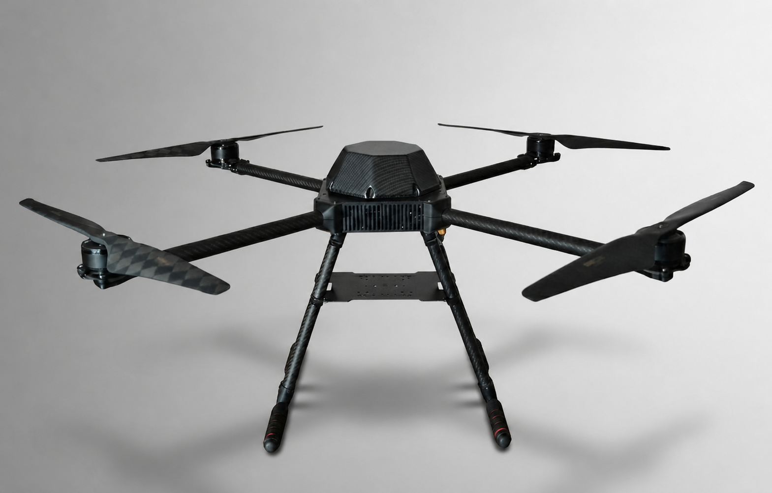 Front view of a carbon-fiber hexacopter airframe in a studio setting.